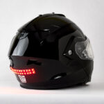 black snowmobile helmet with Biteharder's red helmet safety light installed