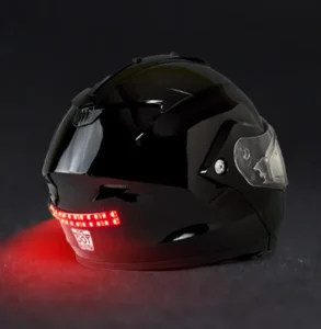 biteharder's helmet safety light attached to a black snowmobile helmet