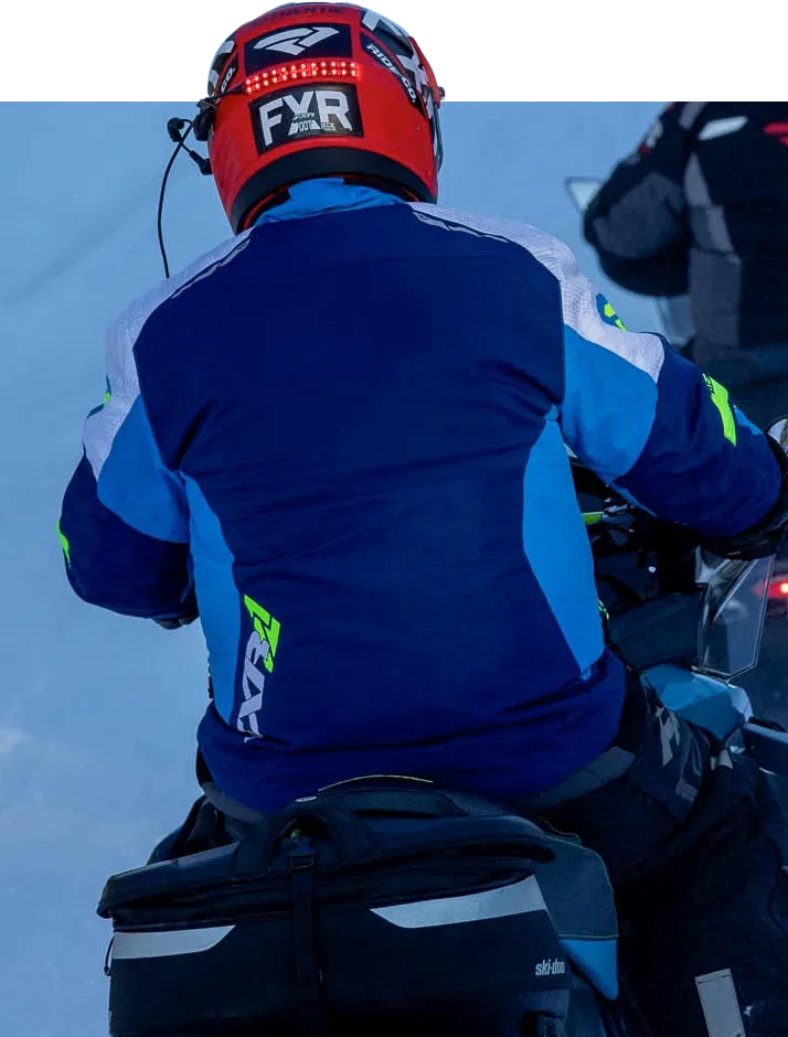 A back view of a snowmobiler with our helmet safety light installed