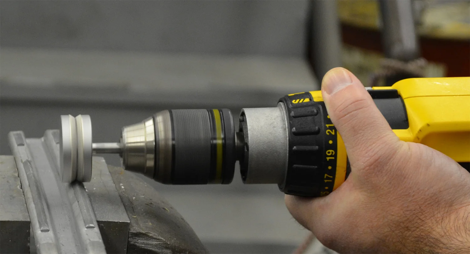 snowmobile runner sharpening tool in use on a runner